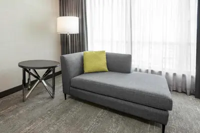 a chair and a table in a hotel room at Hilton Vancouver Metrotown in Burnaby