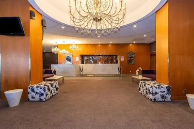 a large banquet hall with a chandelier and a stage at Sandman Signature Edmonton Downtown Hotel in Edmonton