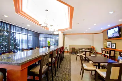 a restaurant with tables and chairs and a large window at Hampton Inn - Vancouver Airport/Richmond in Richmond