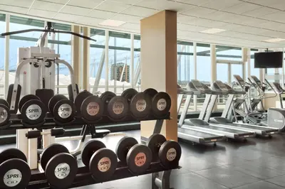 a gym with several rows of dumbbells on display at Hampton Inn & Suites, by Hilton - Vancouver Downtown in Vancouver