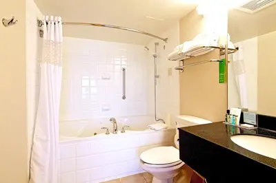 a bathroom with a tub and a toilet and a sink at Hampton Inn & Suites, by Hilton - Vancouver Downtown in Vancouver