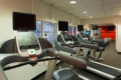 a row of cardio machines in a gym at Radisson Hotel & Suites Fort McMurray in Fort McMurray