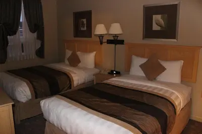 a hotel room with two beds in a room at Clearwater Suite Hotel in Fort McMurray