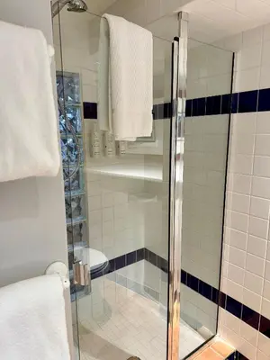 a shower with a glass door in a bathroom at Barclay House Bed and Breakfast in Vancouver