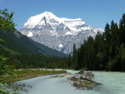 a mountain in the distance with a river and trees at Mica Mountain Lodge & Log Cabins in Tete Jaune Cache