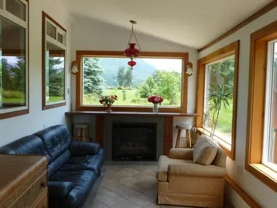a living room with a couch and a fireplace at Harrison Hammond House Farmstay in Harrison Mills