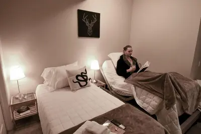 a man sitting in a chair in a room at Misty Ridge Retreat B&B in Foothills