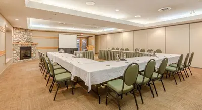 a conference room with a long table and chairs at Tigh-Na-Mara Seaside Spa Resort in Parksville