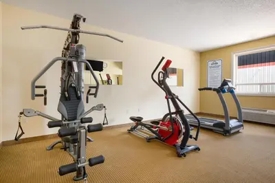 a gym with two treadmills and two exercise bikes at Days Inn by Wyndham Bonnyville in Bonnyville
