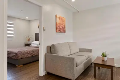 a living room with a couch and a bed at Oasis Inn in Kelowna