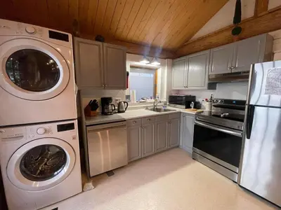 a kitchen with a washer and dryer in it at The Beach House Texada - Gillies Bay Favourite Cabin in Gillies Bay