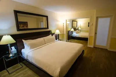 a hotel room with a large bed and a mirror at Rockwater Secret Cove Resort in Sechelt