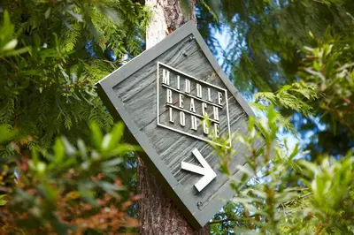 a bird house on the side of a tree at Middle Beach Lodge in Tofino