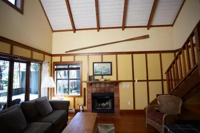 a living room with a couch and a fireplace at Middle Beach Lodge in Tofino