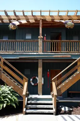 a front porch of a house with a deck at Middle Beach Lodge in Tofino