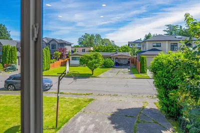 a view from a window of a street with houses at Quite House near the Vancouver Airport in Richmond