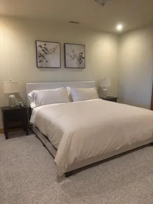 a bedroom with a large white bed with two night stands at Shawnigan Hills Guest Suite in Shawnigan Lake