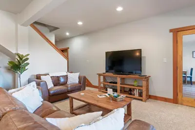 a living room with a couch and a television at Shawnigan Hills Guest Suite in Shawnigan Lake