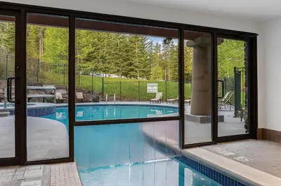 a swimming pool with sliding glass doors in a house at WorldMark Canmore-Banff in Canmore