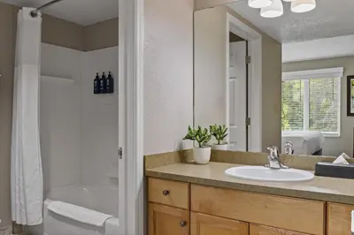 a bathroom with a sink and a tub and a toilet at WorldMark Canmore-Banff in Canmore