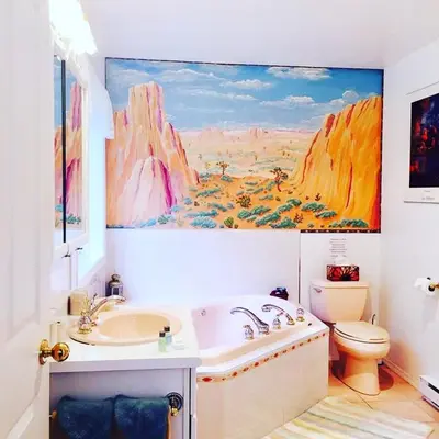 a bathroom with a sink and a painting on the wall at Seafarer Bed & Breakfast in Tofino