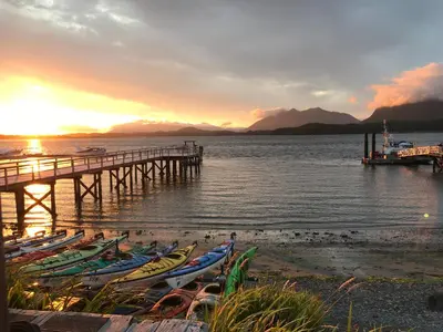 a group of boats parked next to a pier at Tofino Paddlers Inn in Tofino