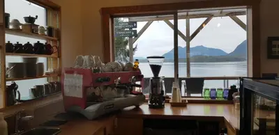 a kitchen counter with a mixer and a window at Tofino Paddlers Inn in Tofino