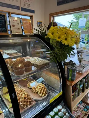 a bakery with waffles and pastries in a display case at Tofino Paddlers Inn in Tofino