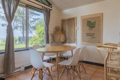 a dining room with a table and chairs and a window at Mackenzie Beach Resort in Tofino