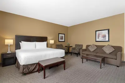 a hotel room with a bed and a couch at Best Western Plus Baker Street Inn in Nelson