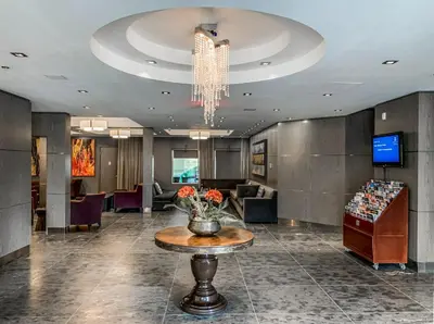 a lobby with a vase of flowers on a table at The Mountaineer by InstantSuites Pool & HotTub in Canmore