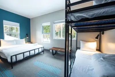 two bunk beds in a room with blue walls at Nowhere Special Hostel in Rossland