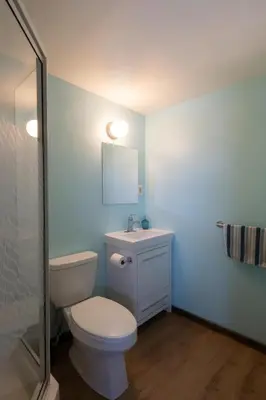 a bathroom with a toilet and a sink and a mirror at Dreamcatcher Hostel in Golden