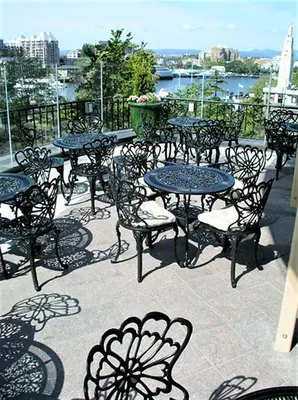 a group of tables and chairs on a patio at The Inn at the Union Club of British Columbia in Victoria