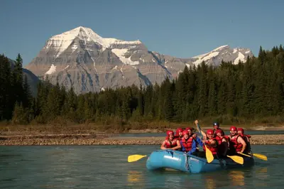 a group of people in a raft on a river at Mount Robson Lodge in Mount Robson