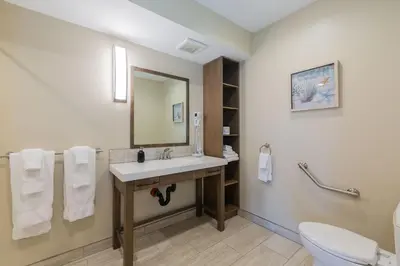 a bathroom with a sink and a toilet at Mayne Island Resort in Mayne Island