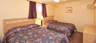 a hotel room with two beds and a window at Black Sea Motel in Penticton