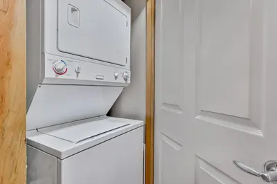 a white refrigerator with its door open in a kitchen at Suites with Pool & Hot tubs managed by Little Sister Getaways in Canmore