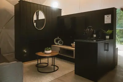a black room with a table and a mirror at West Coast Trail Lodge in Port Renfrew