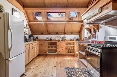 a kitchen with wooden floors and a white refrigerator at Owl Street Lodge in Hope