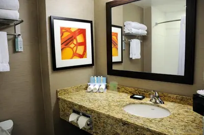 a bathroom with a sink and a mirror at Chateau Inn & Suites Bonnyville in Bonnyville