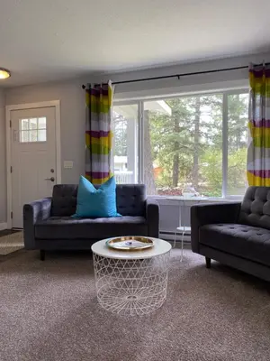 a living room with two couches and a coffee table at Stoneshire Guesthouse in Clearwater