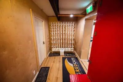 an empty hallway with a door and a basketball at Red Shutter Inn in Rossland