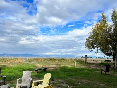 a group of chairs sitting in a field at Sea Edge Beachside Hotel in Parksville
