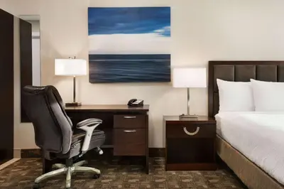 a hotel room with a bed and a desk with a chair at Days Inn by Wyndham Wainwright in Wainwright