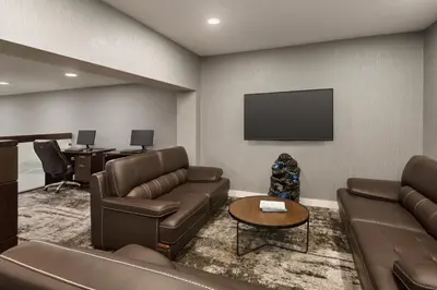 a waiting room with couches and a flat screen tv at Days Inn by Wyndham Wainwright in Wainwright