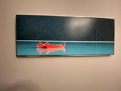 a painting of a red boat on a wall at Wolf Den in Valemount