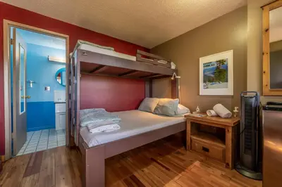 a bedroom with a bunk bed in a room at The Raging Elk Adventure Lodging in Fernie
