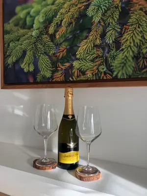 a bottle of wine and two wine glasses on a table at Sounds of the Sea in Ucluelet