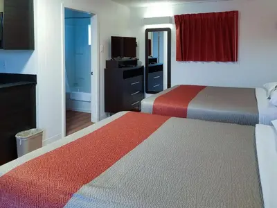 a hotel room with two beds and a television at Motel 6-Cranbrook, BC in Cranbrook